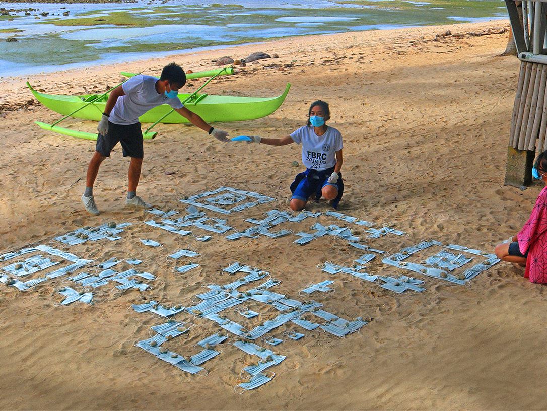 Rizza Mae Hibaya and her friends creating the QR Code on Tag-ulo beach.